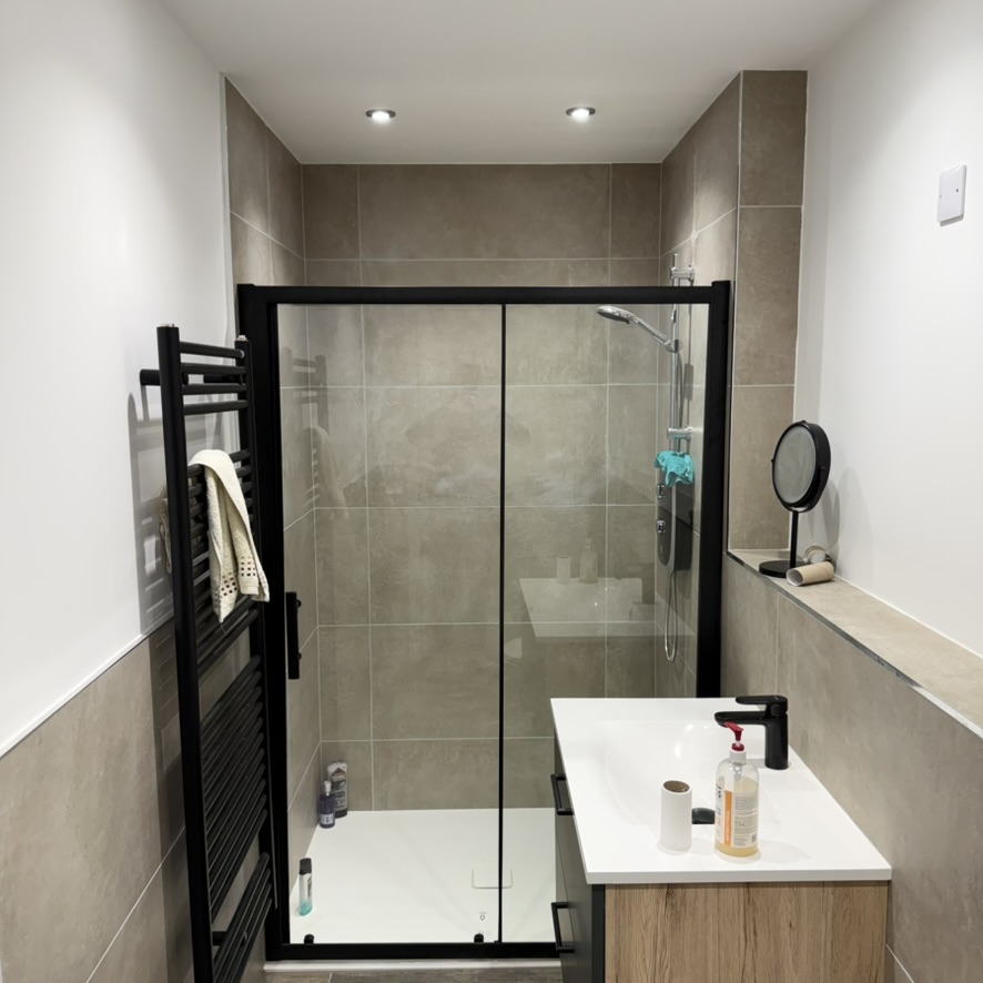 Finished bathroom with walk-in shower and vanity illustrating Granite Builders bathroom fitting across Aberdeenshire