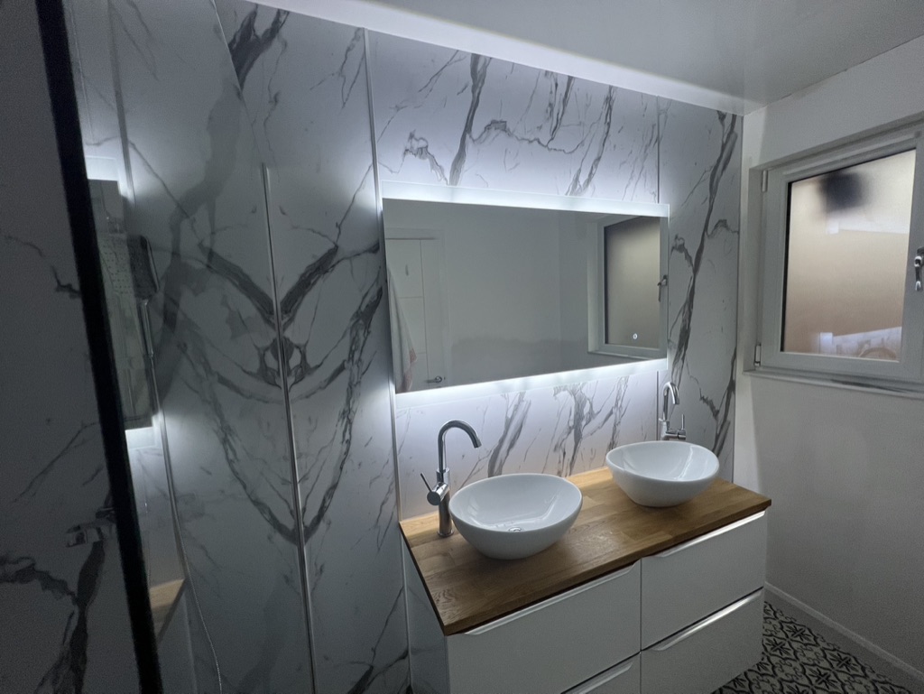 Marble bathroom with a double vanity completed by Granite Builders in Aberdeen