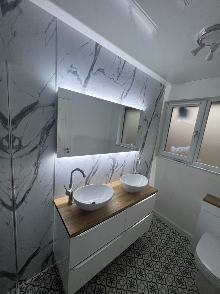 Marble panelled bathroom designed and installed by Granite Builders in Aberdeen