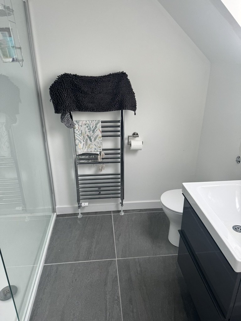 Renovated family bathroom in a Portlethen home with a heated towel rail, freestanding bath and dark tiled floor