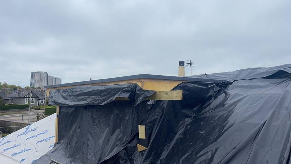Temporary sheeting over a new extension roof structure to keep the rain out during the build, Aberdeen