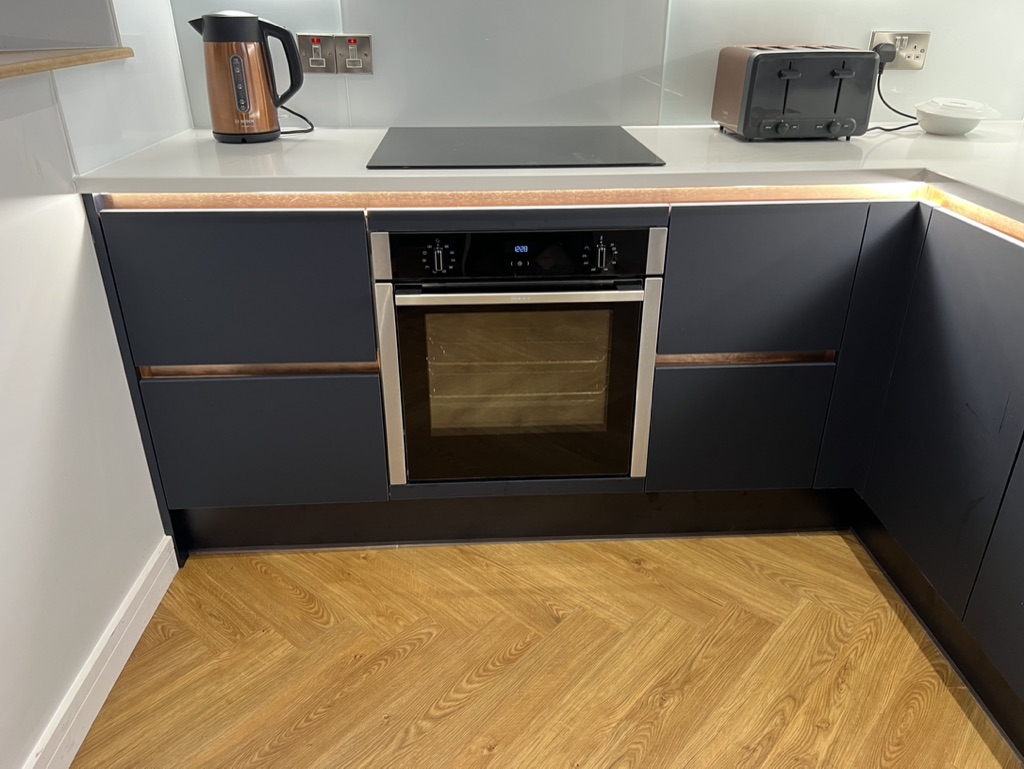 Navy blue kitchen with oven units designed and fitted by Granite Builders in Aberdeen