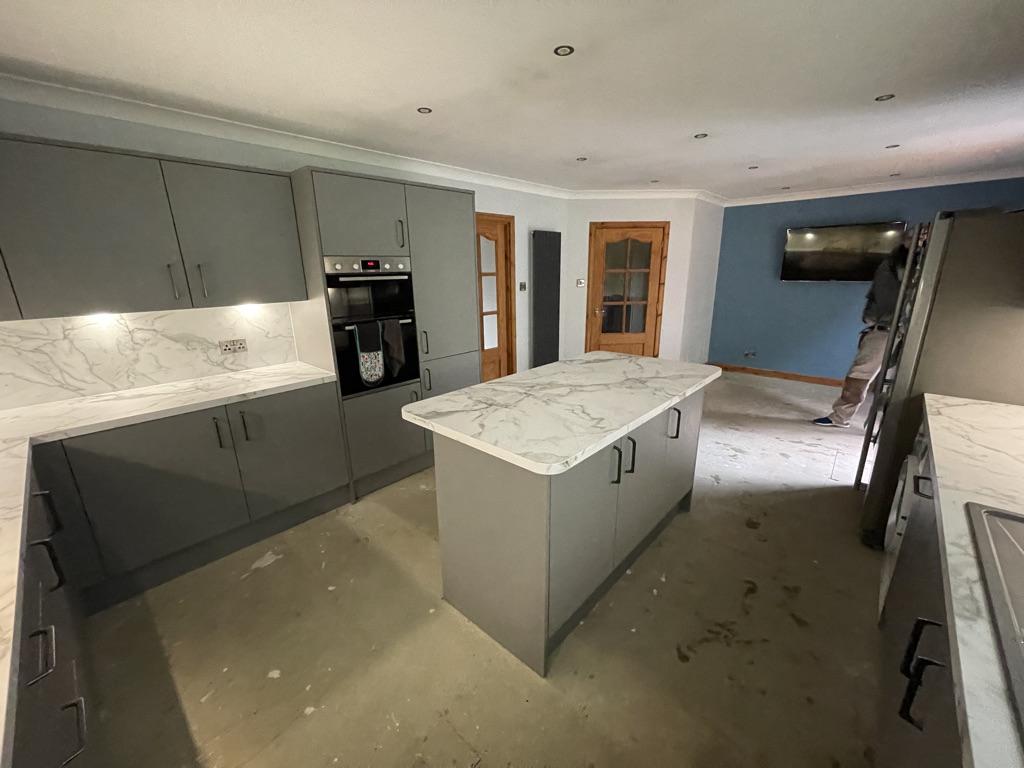 Finished open plan kitchen diner with island and integrated oven in Aberdeenshire