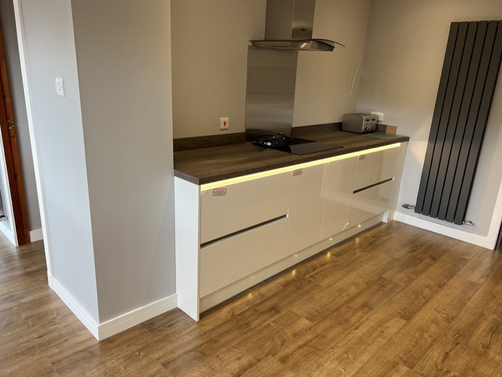 Finished kitchen with hob and extractor completed by Granite Builders in Westhill