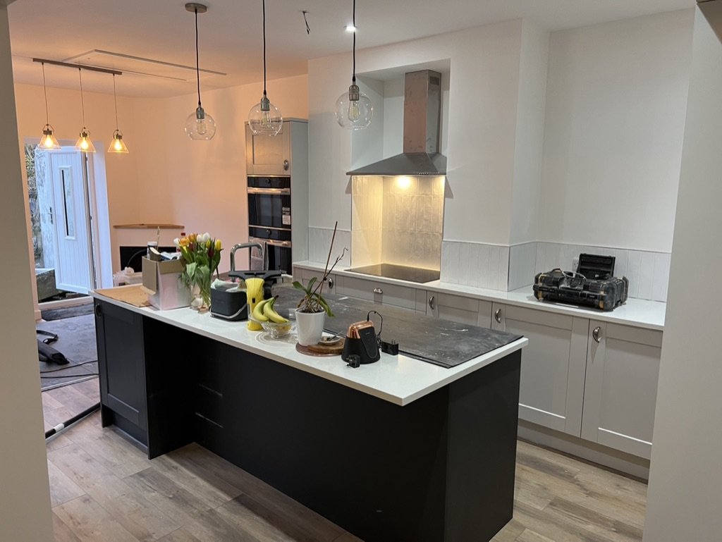 Completed kitchen extension in Aberdeen with a large island, pendant lighting and integrated appliances