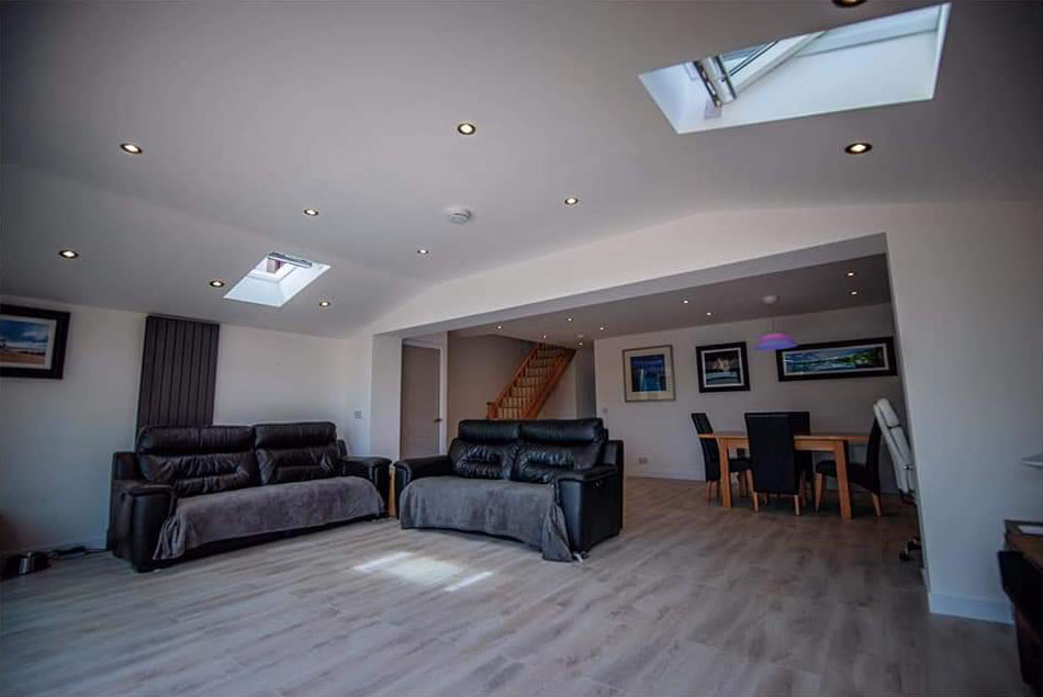 Finished open-plan home extension with two Velux skylights and a wide structural opening through to the original house