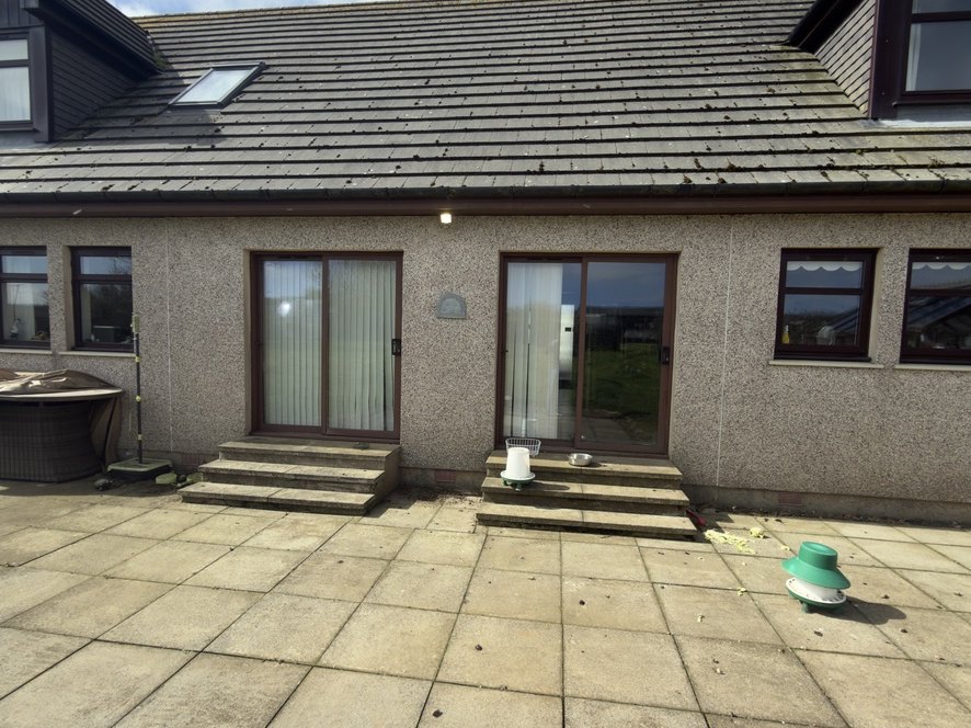 Rear of the Peterhead house before work, showing the two separate patio doors that were removed to form one wide opening