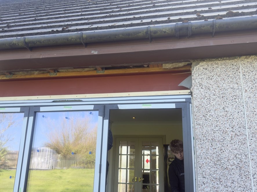 Single wide structural opening formed at the rear of the Peterhead house, with the steel beam in place above and the new door frame going in